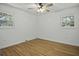 Simple bedroom with hardwood floors, ceiling fan and two windows at 1134 Mim Ave, Charleston, SC 29407