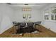 Bright dining room with hardwood floors, a rustic table, and modern chairs at 1134 Mim Ave, Charleston, SC 29407