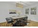 Bright dining room with hardwood floors, a rustic table, and modern chairs at 1134 Mim Ave, Charleston, SC 29407