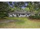 Front view of a white brick ranch house with a lush lawn at 1134 Mim Ave, Charleston, SC 29407