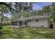 White brick house with screened porch and large backyard at 1134 Mim Ave, Charleston, SC 29407