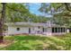 White brick house with screened porch and large backyard at 1134 Mim Ave, Charleston, SC 29407