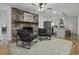 Living room with brick fireplace and hardwood floors, open to kitchen at 1134 Mim Ave, Charleston, SC 29407
