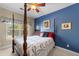 Bedroom with a four-poster bed, blue accent wall, and ceiling fan at 133 Manning Ct, Summerville, SC 29485