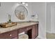 Vanity with granite countertop and a large round mirror at 1449 Waterside Ct, Mount Pleasant, SC 29464