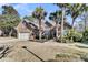 Brick house with palm trees, landscaped yard, and attached garage at 1449 Waterside Ct, Mount Pleasant, SC 29464