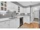 Modern white kitchen with stainless steel appliances and gray tile backsplash at 1449 Waterside Ct, Mount Pleasant, SC 29464