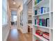 Home hallway, featuring built-in bookshelves and hardwood floors at 1525 Kepley Dr, Mount Pleasant, SC 29464