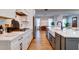 Modern kitchen with white cabinets, a large island with farmhouse sink, and stainless steel appliances at 1525 Kepley Dr, Mount Pleasant, SC 29464
