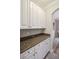 White cabinets and granite countertop butlers pantry at 1654 Sparkleberry Ln, Johns Island, SC 29455