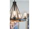 Five-light wood and metal chandelier at 1654 Sparkleberry Ln, Johns Island, SC 29455