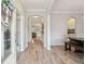 Light-filled entryway with hardwood floors and archways at 1654 Sparkleberry Ln, Johns Island, SC 29455