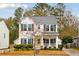 Two-story home with a yellow door and landscaping at 1654 Sparkleberry Ln, Johns Island, SC 29455