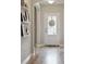 Bright hallway with hardwood floors and built-in shelves at 1654 Sparkleberry Ln, Johns Island, SC 29455