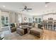 Spacious living room with L-shaped sectional sofa and hardwood floors at 1654 Sparkleberry Ln, Johns Island, SC 29455
