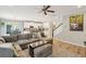 Open living room with sectional sofa and hardwood floors at 1654 Sparkleberry Ln, Johns Island, SC 29455