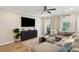 Living room with sectional sofa and large TV at 1654 Sparkleberry Ln, Johns Island, SC 29455