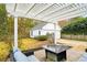 Relaxing pergola with seating area and fire pit, overlooking the backyard at 1654 Sparkleberry Ln, Johns Island, SC 29455