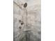 Modern shower with gray tile, a built-in corner shelf, and updated fixtures at 1654 Sparkleberry Ln, Johns Island, SC 29455