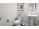 Small bathroom with white toilet and pedestal sink at 2020 Parish House Cir, Johns Island, SC 29455
