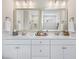 Bright bathroom boasts double sinks, marble countertops, and large mirrors at 2020 Parish House Cir, Johns Island, SC 29455
