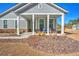 Gray house with a front porch and landscaped yard at 2020 Parish House Cir, Johns Island, SC 29455