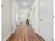 Long hallway with hardwood floors and white doors at 2020 Parish House Cir, Johns Island, SC 29455