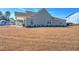Gray house with brown lawn and backyard at 2020 Parish House Cir, Johns Island, SC 29455