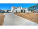 Gray house with driveway and brown lawn at 2020 Parish House Cir, Johns Island, SC 29455