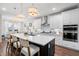 Modern kitchen with white cabinets, large island, and stainless steel appliances at 2020 Parish House Cir, Johns Island, SC 29455