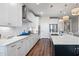 Modern kitchen with white cabinets, stainless steel appliances, and a large island at 2020 Parish House Cir, Johns Island, SC 29455
