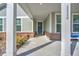 Front porch with white columns and blue door at 2020 Parish House Cir, Johns Island, SC 29455