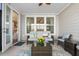 Relaxing screened porch with comfortable seating and views of the backyard at 2020 Parish House Cir, Johns Island, SC 29455