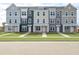 Front view of three-story townhomes with gray and beige siding at 216 Yorkshire Dr # 3, Moncks Corner, SC 29461
