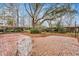 Spacious brick patio surrounded by mature trees and landscaping, offering a tranquil outdoor space at 2216 S Dallerton Cir, Charleston, SC 29414