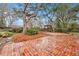 Large brick patio, perfect for outdoor entertaining, nestled in a lush, tree-filled backyard at 2216 S Dallerton Cir, Charleston, SC 29414