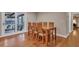 Charming dining area with wood table and chairs, hardwood floors, and access to sunroom at 2216 S Dallerton Cir, Charleston, SC 29414