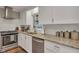 Modern kitchen with granite countertops, white cabinets, and stainless steel appliances at 2216 S Dallerton Cir, Charleston, SC 29414
