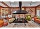Sunroom with a large metal fireplace and brick walls at 2216 S Dallerton Cir, Charleston, SC 29414