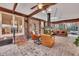 Sunroom with brick floor, fireplace, and access to backyard at 2216 S Dallerton Cir, Charleston, SC 29414
