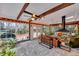 Sunroom features exposed beams, brick flooring, and a fireplace at 2216 S Dallerton Cir, Charleston, SC 29414