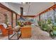 Relaxing sunroom with brick flooring, exposed beams, and comfortable seating at 2216 S Dallerton Cir, Charleston, SC 29414