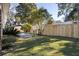 Landscaped backyard with a wooden fence and patio at 2383 Erskine Ct, Charleston, SC 29414