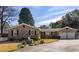 Brick ranch house with 2-car garage, landscaped yard, and white picket fence at 2383 Erskine Ct, Charleston, SC 29414
