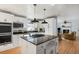 Open concept kitchen with island, stainless steel appliances, and view to living room at 2383 Erskine Ct, Charleston, SC 29414