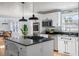 Modern kitchen with white cabinets, granite island, and stainless steel appliances at 2383 Erskine Ct, Charleston, SC 29414