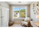 Relaxing bedroom with a rocking chair, large window, and a view of the backyard at 2737 Sarazen Dr, Mount Pleasant, SC 29466