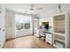Bright bedroom with built-in desk and shelving, hardwood floors, and large window at 2737 Sarazen Dr, Mount Pleasant, SC 29466