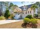 Tan two-story house with a white porch and attached garage at 2737 Sarazen Dr, Mount Pleasant, SC 29466
