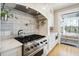 Modern kitchen features a gas range, custom cabinetry, and a beautiful backsplash at 2737 Sarazen Dr, Mount Pleasant, SC 29466